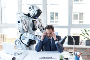 Man in suit is expressing suffering while sitting at table